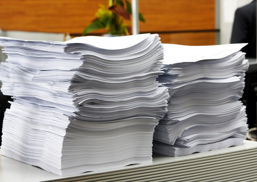 The paper stack in office as a symbol of bureaucracy and civil servants.